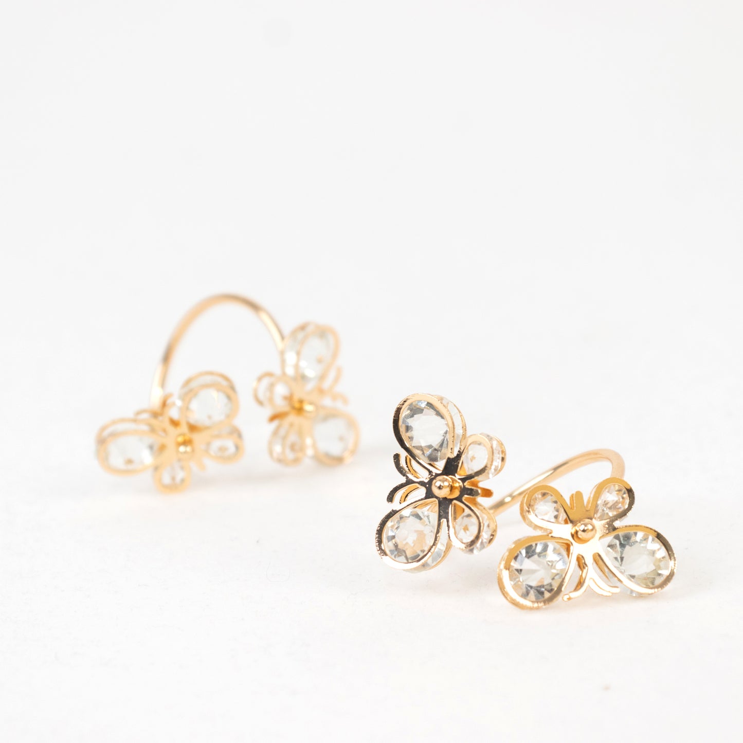 Gold butterfly napkin holders with crystal accents for weddings and events.