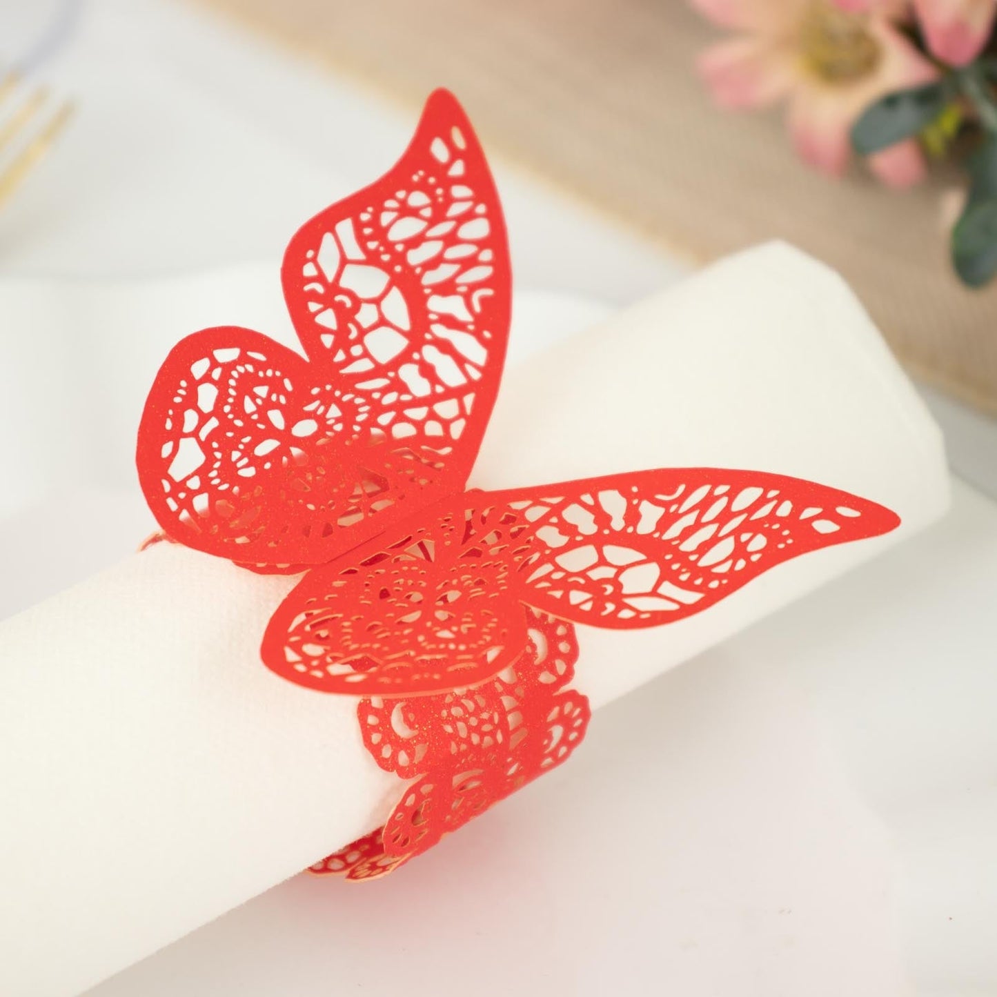 Red shimmery laser cut butterfly napkin ring holder.