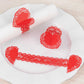Red shimmery laser cut heart napkin holders with lace pattern.