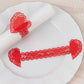 Red shimmery laser cut heart paper napkin holders with lace pattern.
