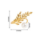 Gold leaf napkin ring with white pearl accent, elegant table décor.