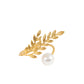 Gold leaf napkin ring with white pearl accent for wedding table décor.