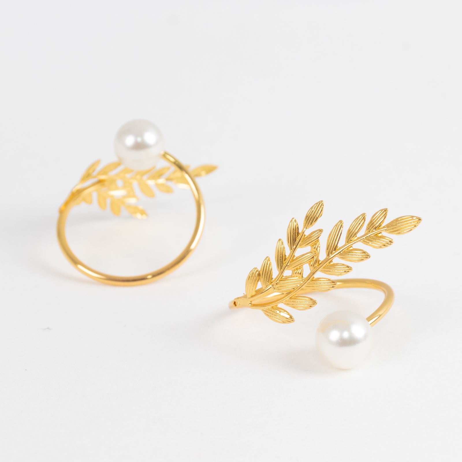 Gold napkin rings with white pearl accent, wheat leaf design.