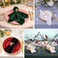 Gold leaf napkin rings with white pearl accent on elegant table setting.