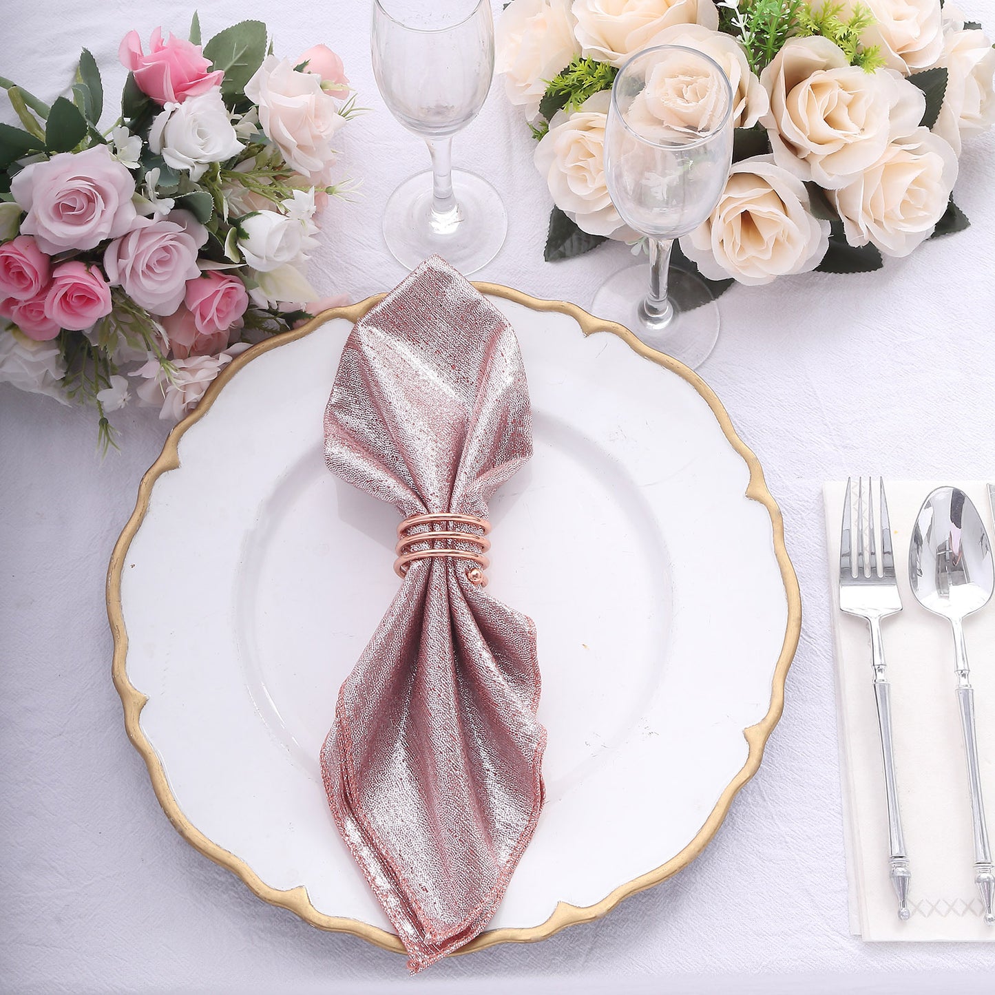 Rose gold shimmer sequin table napkins on a white plate.