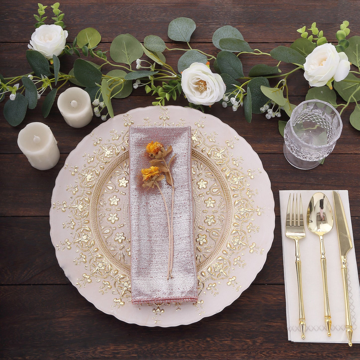 Rose gold shimmer sequin dots polyester table napkins on a decorative plate.