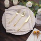 Beige shimmer sequin dot table napkin with gold utensils and floral decor.
