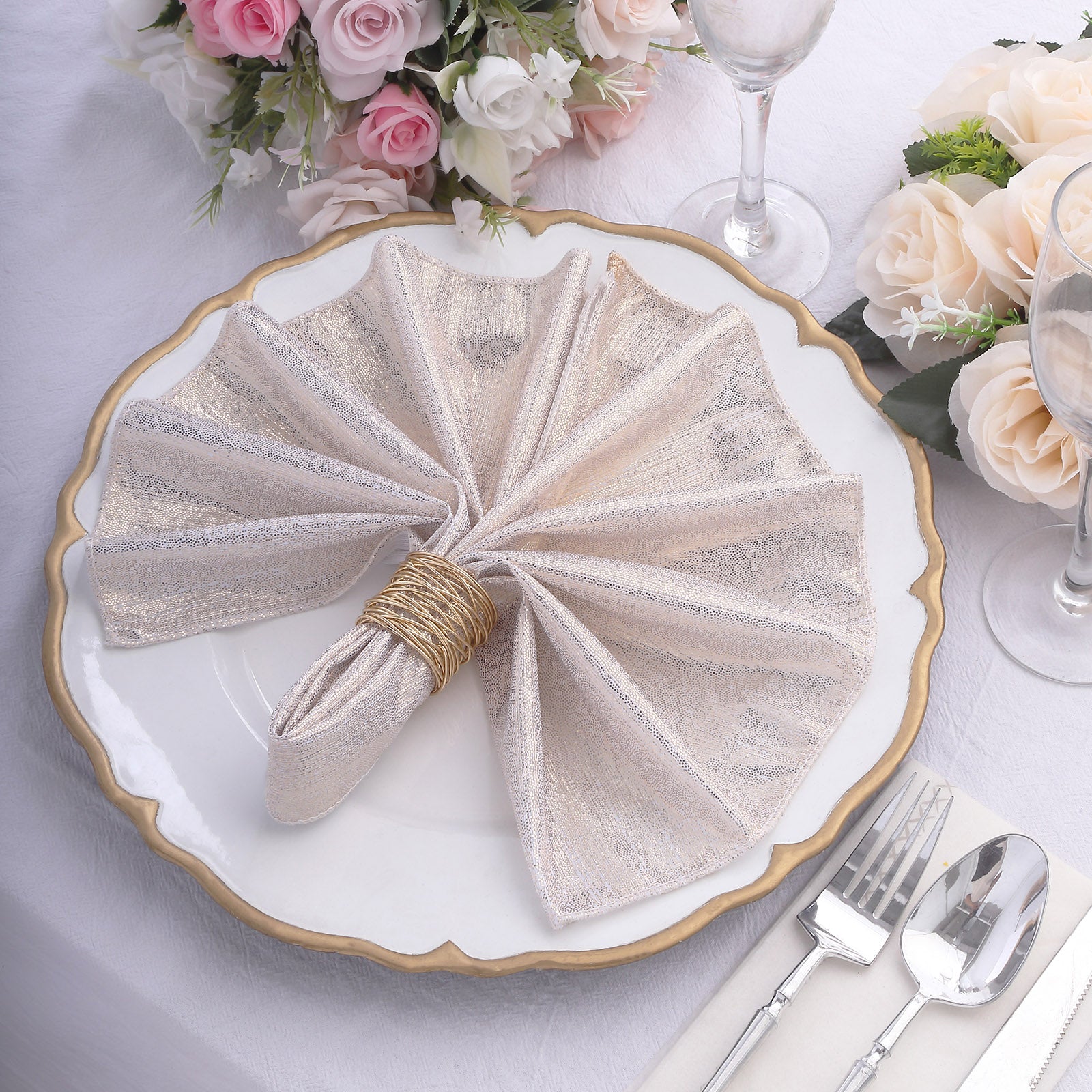 Beige shimmer sequin table napkin on a beautifully set dining table.