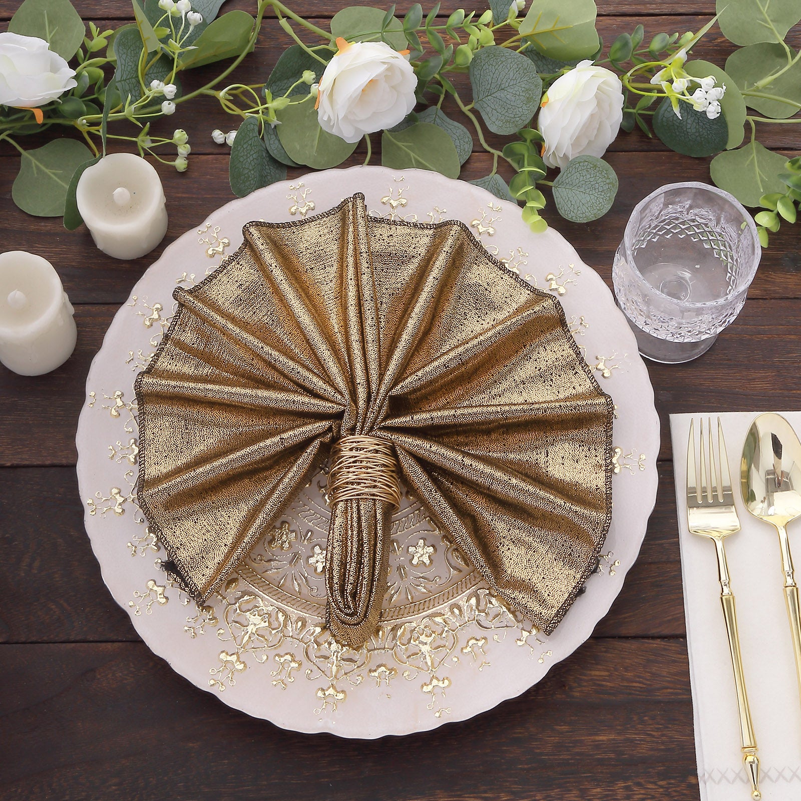 Antique gold shimmer sequin dot napkins on a decorative plate.