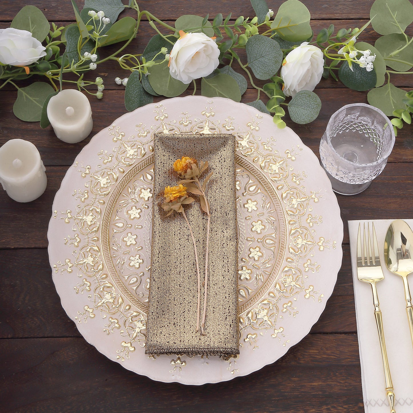 Antique gold shimmer sequin dots table napkin on a decorated dinner plate.