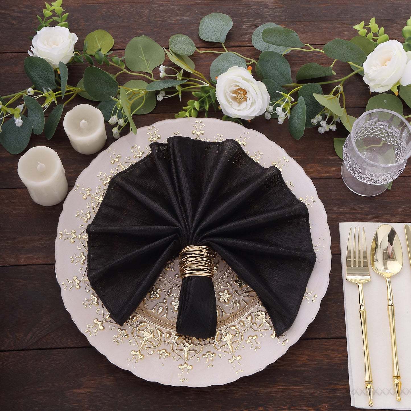 Black shimmer sequin napkin on an elegant dinner plate setting.