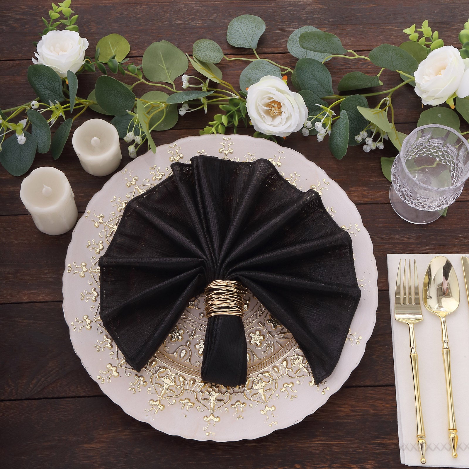 Black shimmer sequin napkin on an elegant dinner plate setting.