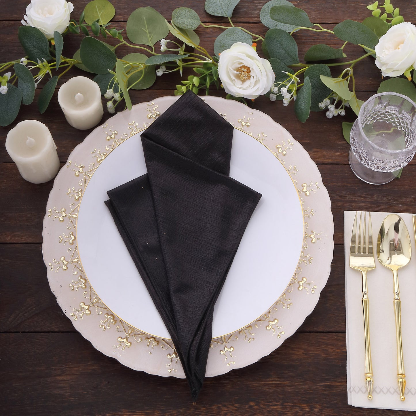 Black shimmer sequin table napkins on an elegant dinner setting.