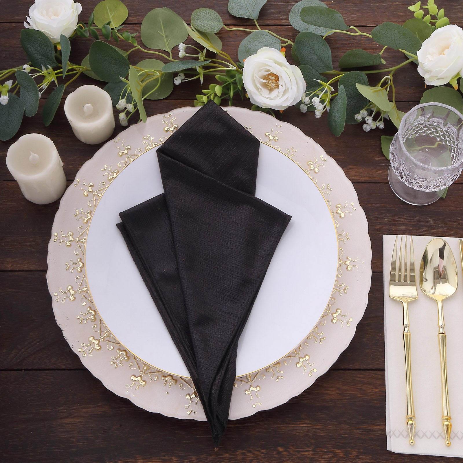 Black shimmer sequin table napkins on an elegant dinner setting.
