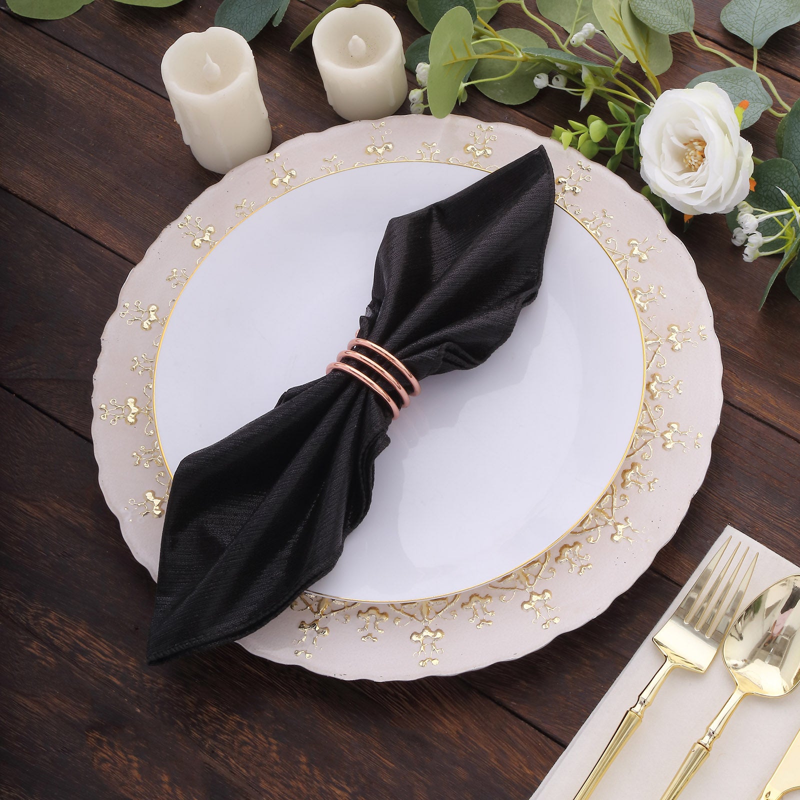 Black shimmer sequin table napkins on a dinner plate setting.