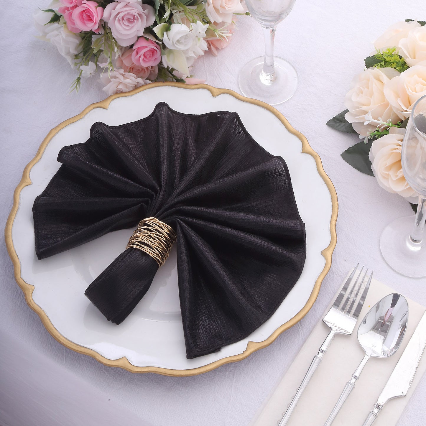 Black shimmer sequin napkin elegantly arranged on a formal dinner table setting.