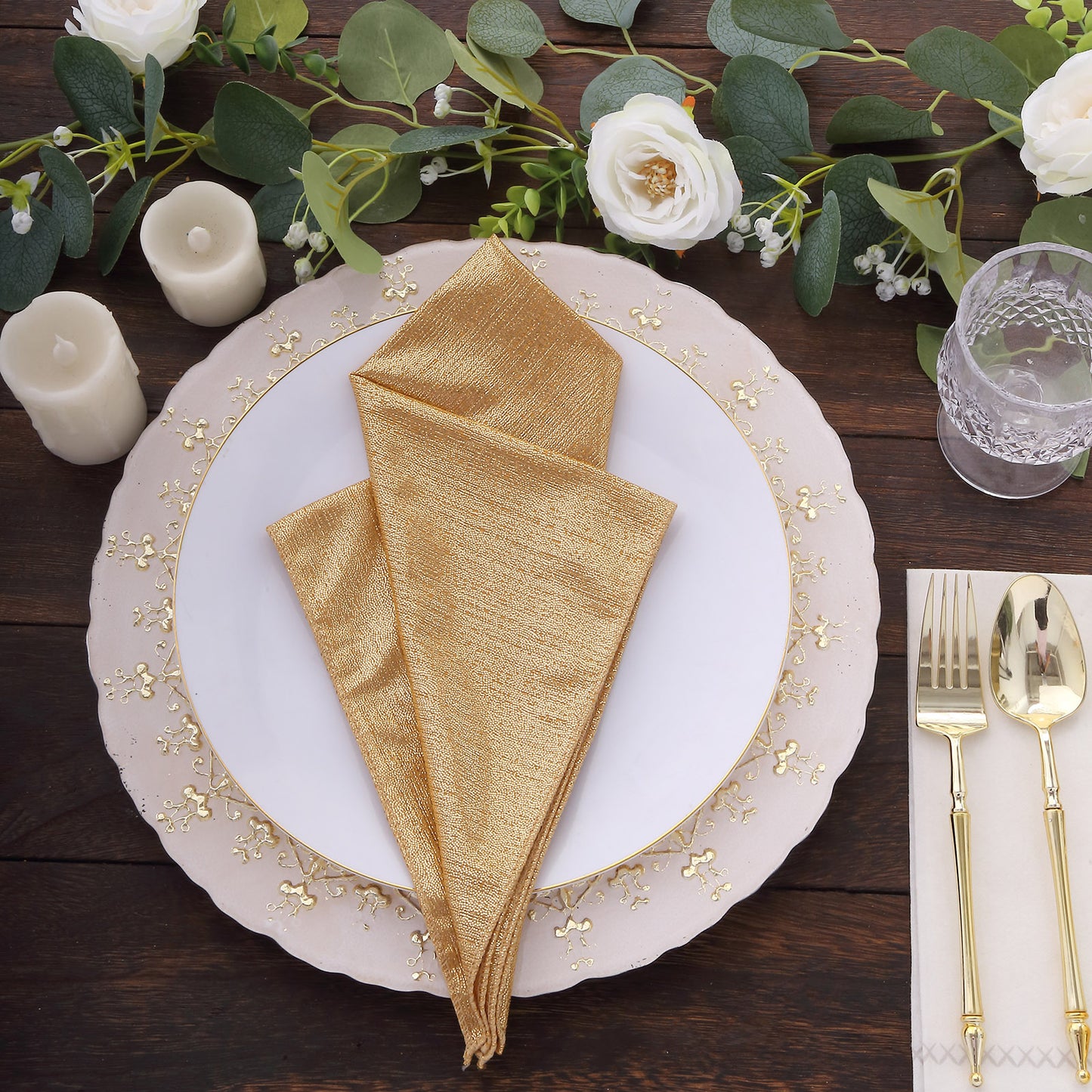 Gold shimmer sequin napkins on a dining table setting.