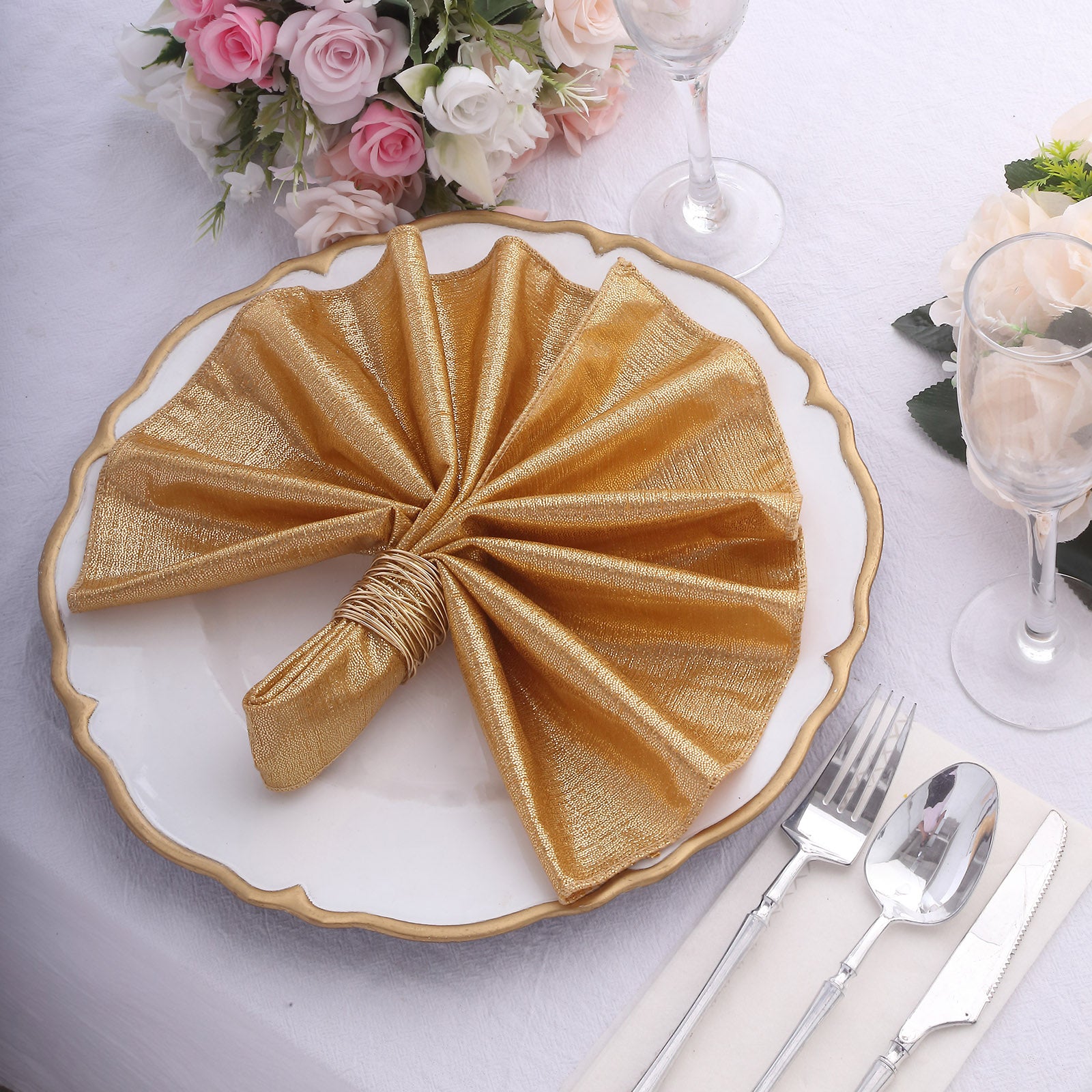 Gold shimmer sequin dots table napkin on a decorative plate.
