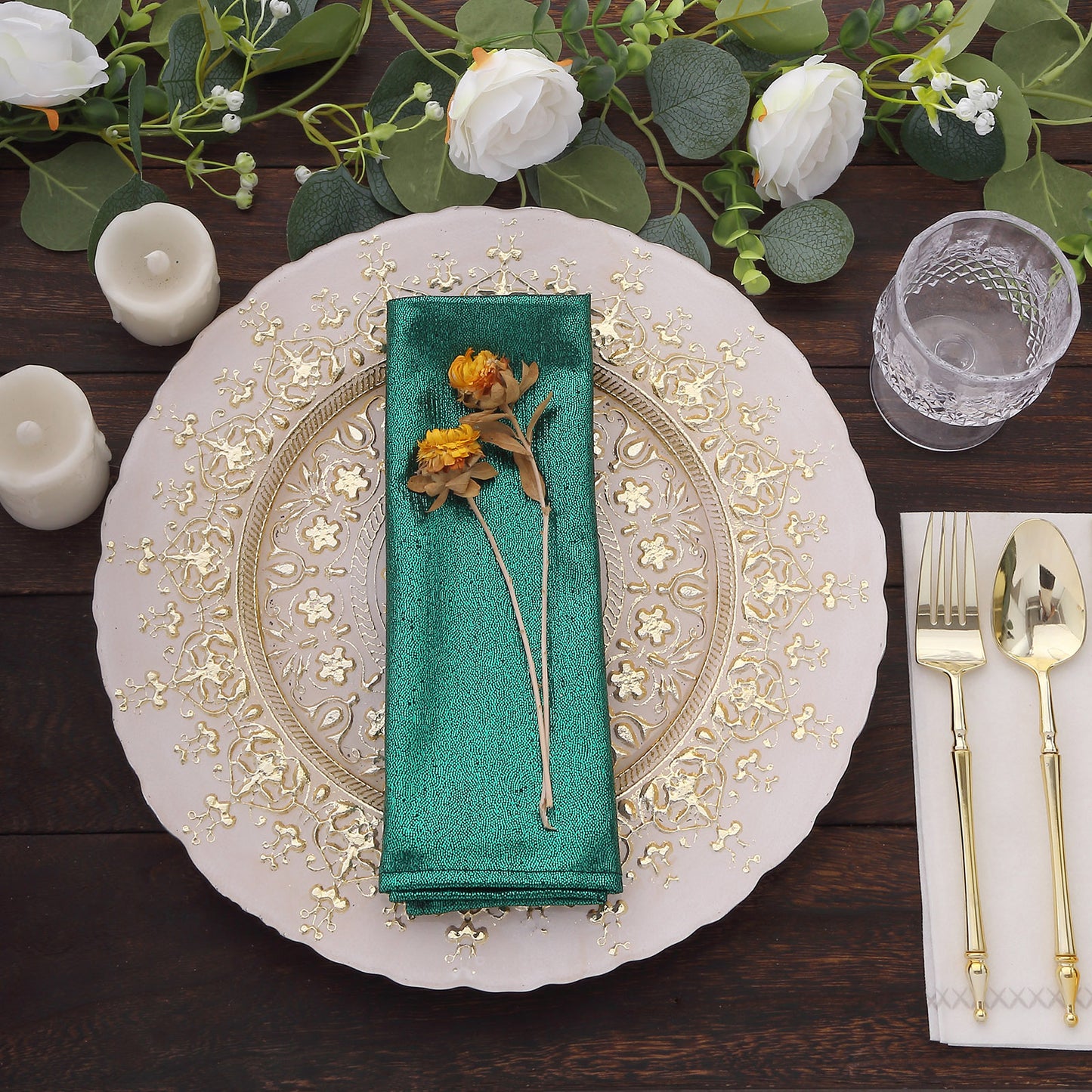 Emerald green shimmer sequin table napkin on a decorative plate.