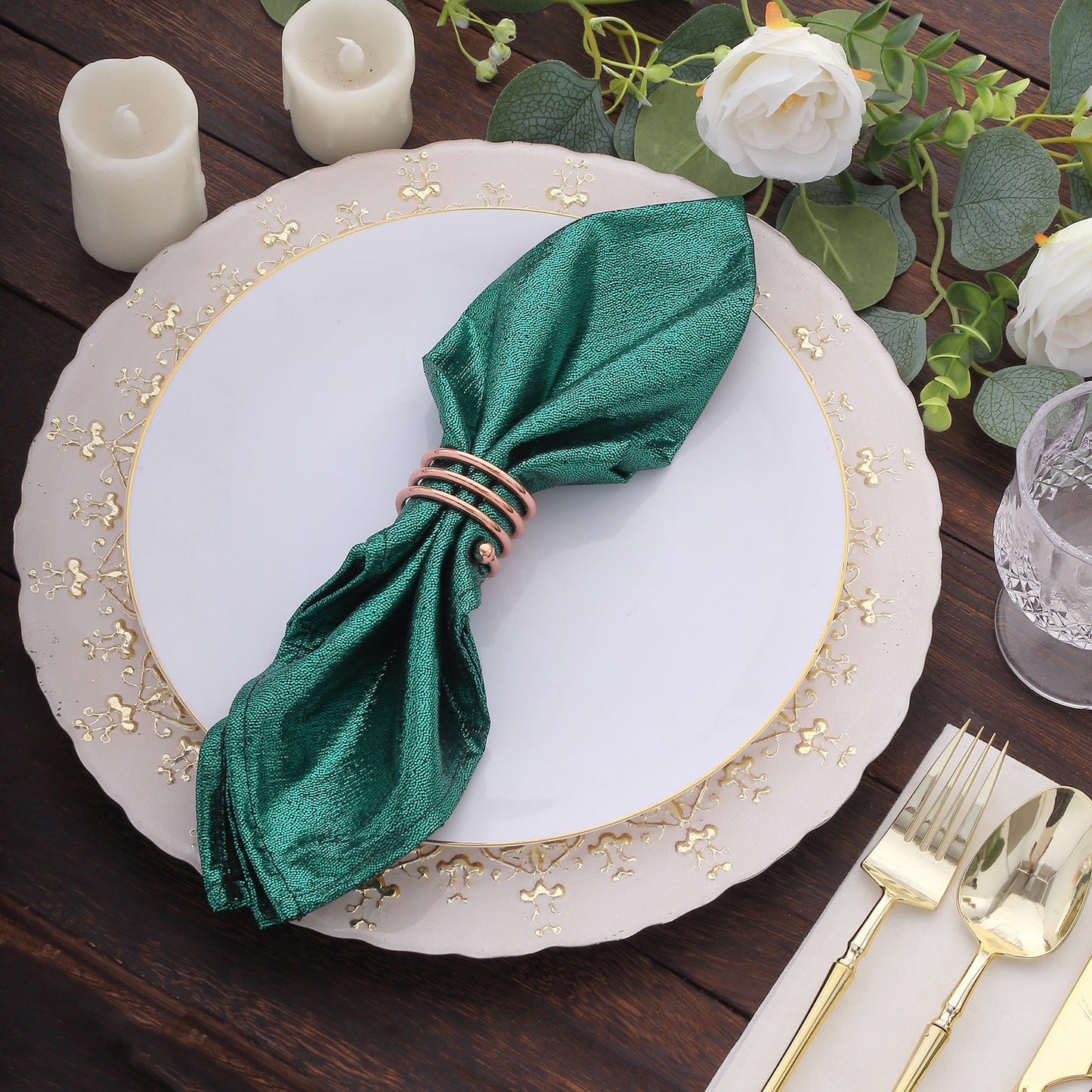 Emerald green shimmer sequin table napkin on a decorative plate.