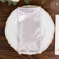 Silver shimmer sequin cloth napkin on a decorative plate.