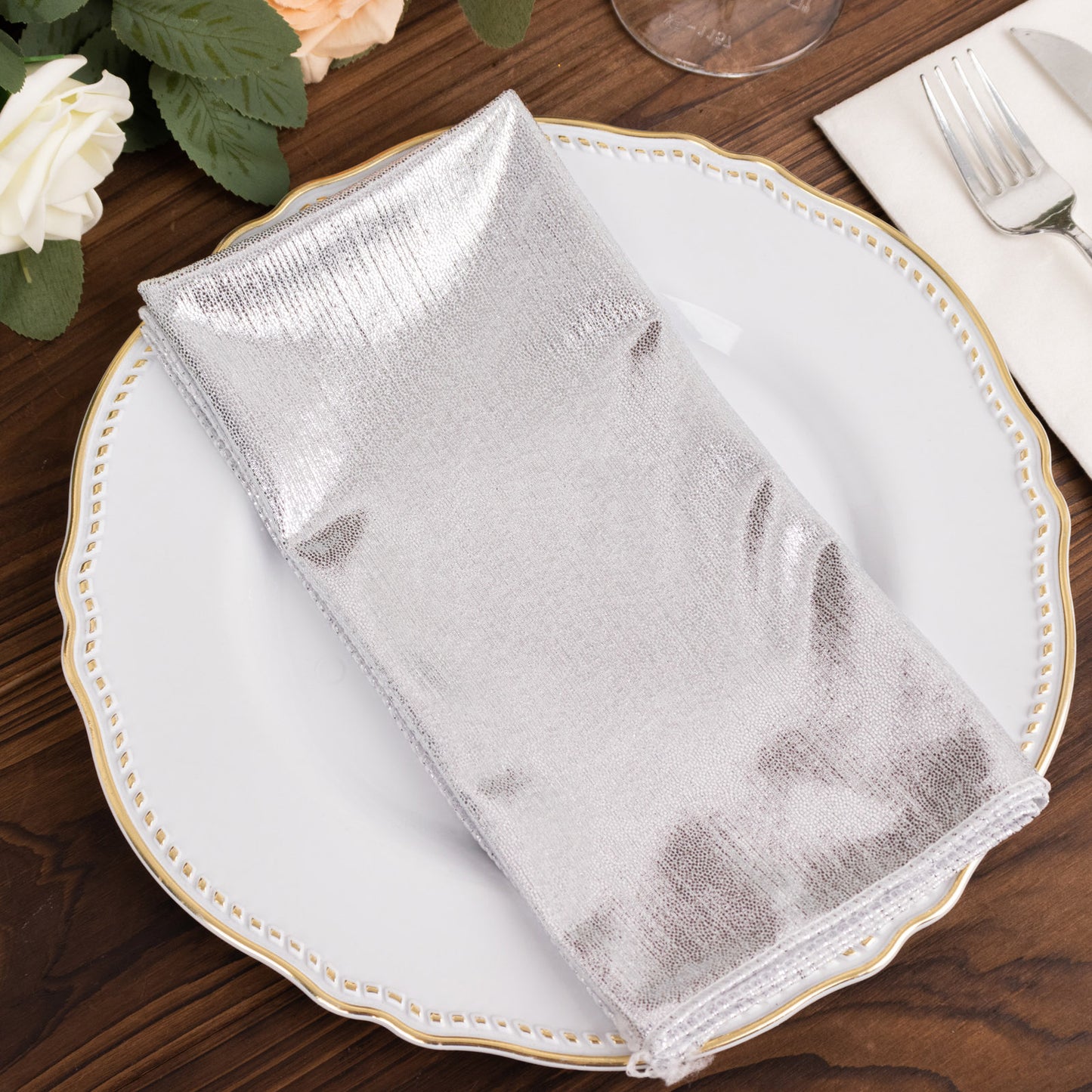 Silver shimmer sequin table napkin on a plate, reusable and elegant.