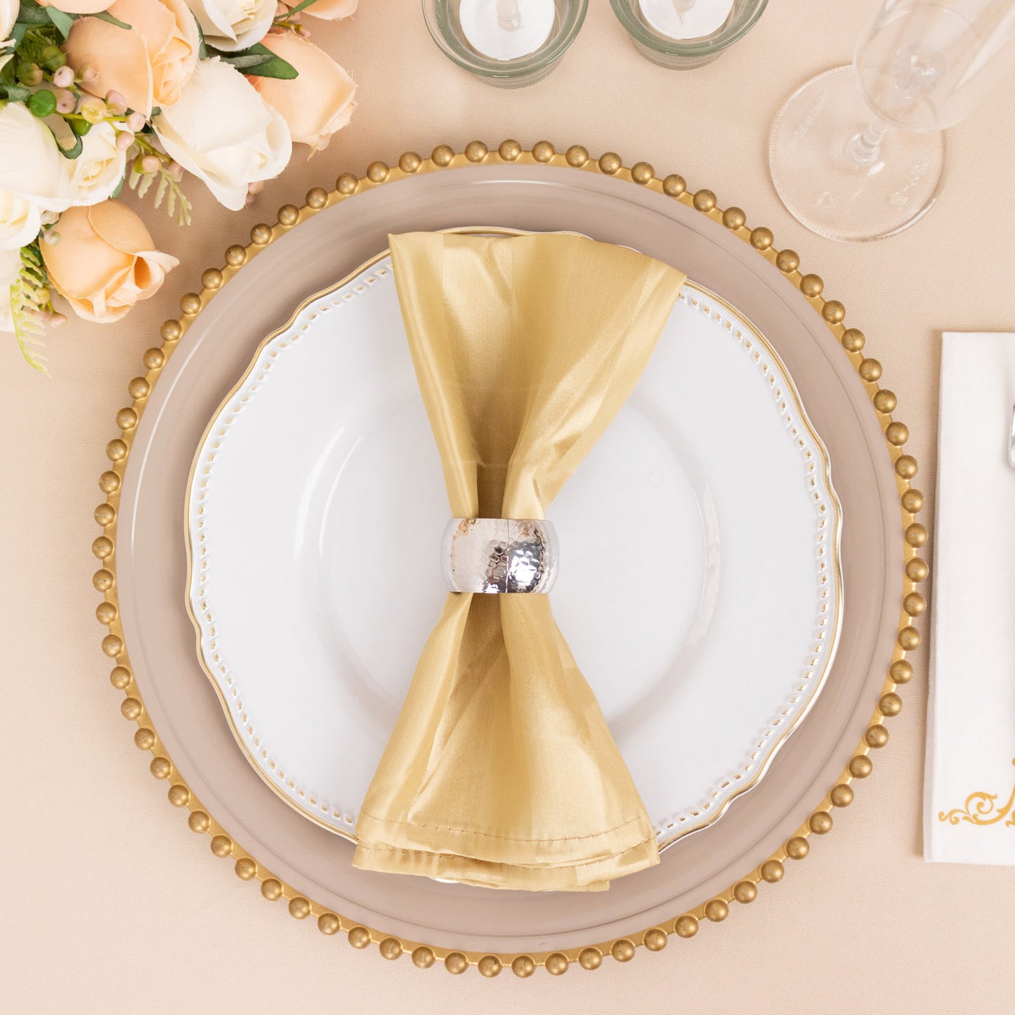 Champagne satin linen napkin elegantly styled on a dinner plate.