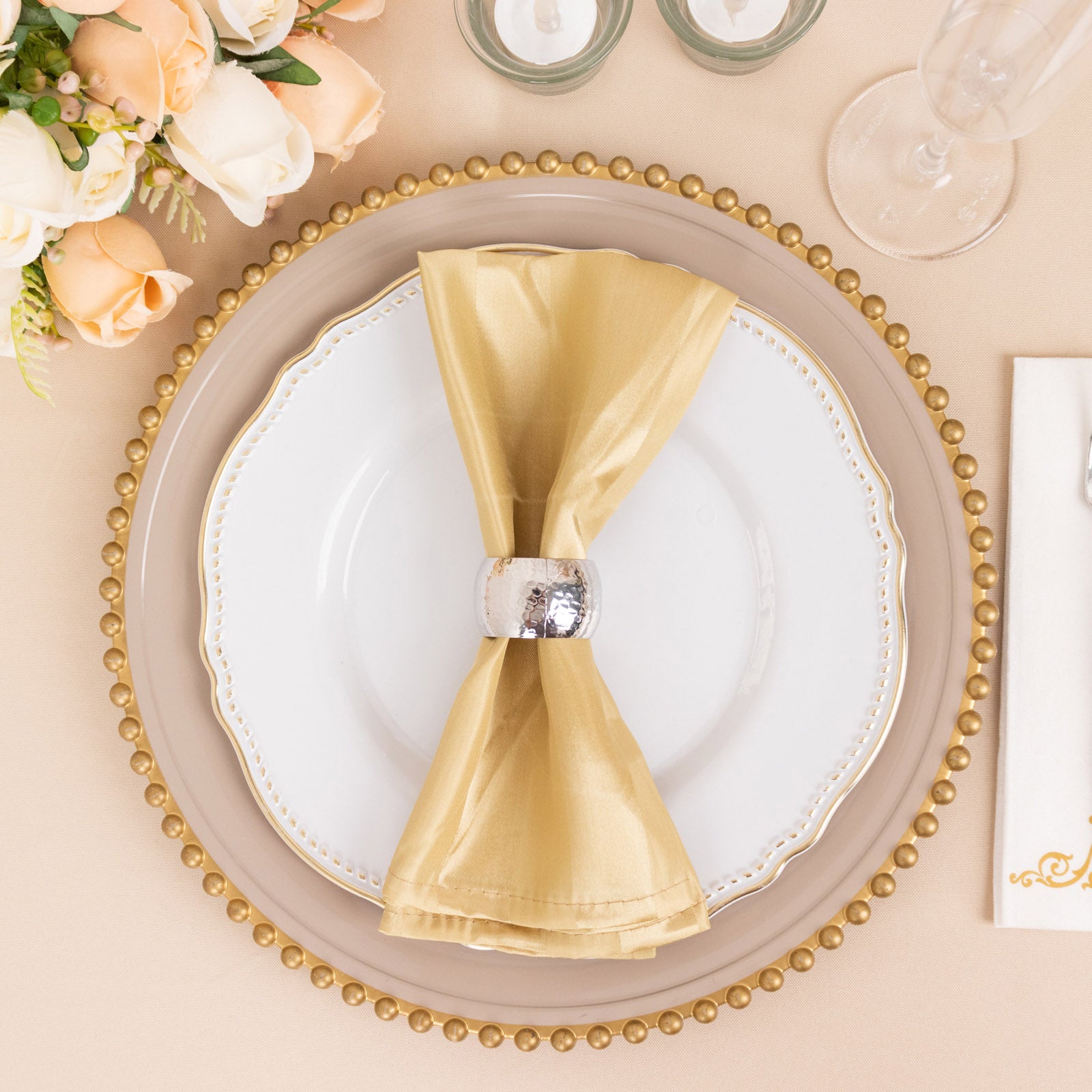Champagne satin linen napkin elegantly styled on a dinner plate.