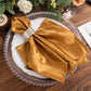 Gold satin linen napkin on an elegant table setting.