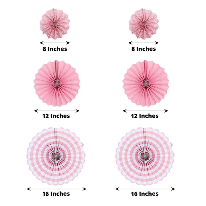 Pink hanging paper fan decorations in various sizes for party backdrop.