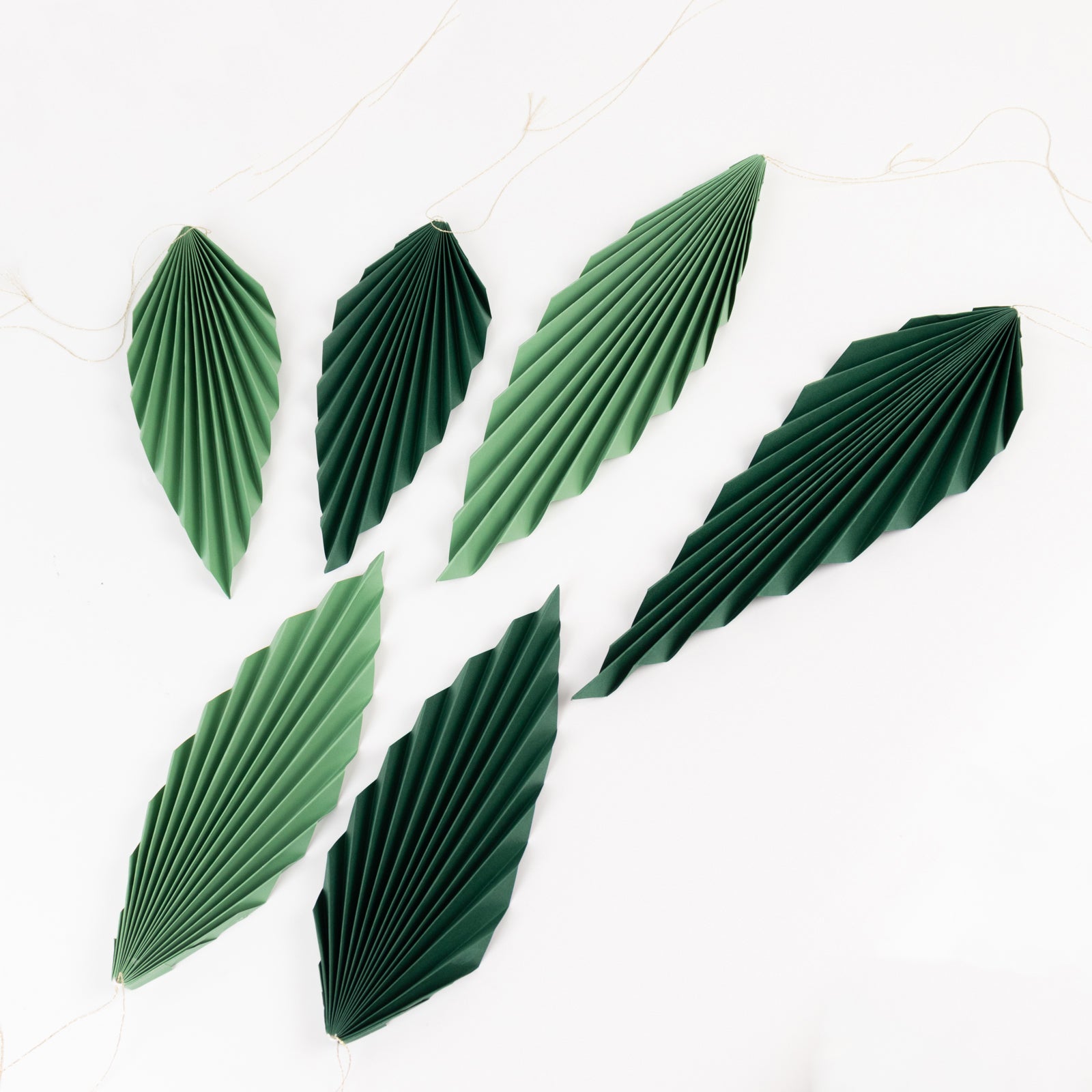 Set of 6 mixed green leaves paper fans for tropical party decor.