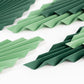 Set of 6 mixed green leaves hanging paper fans for tropical party decor.