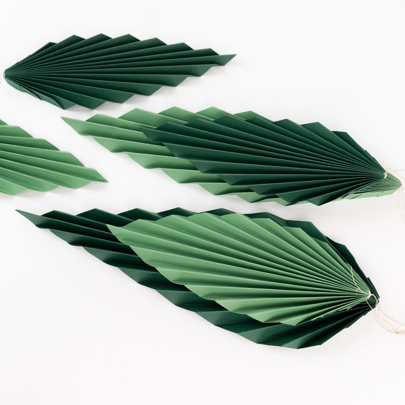 Set of 6 mixed green leaves paper fans for tropical decor.