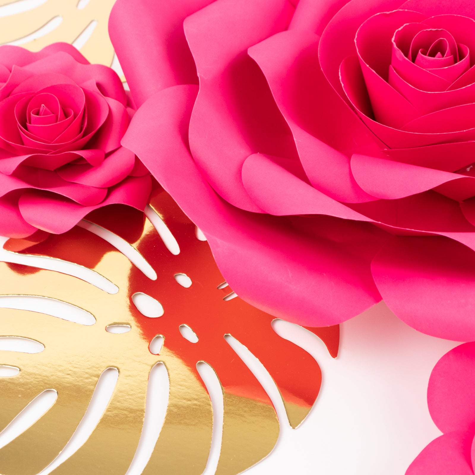 Fuchsia 3D rose paper flowers with gold tropical palm leaves decor.