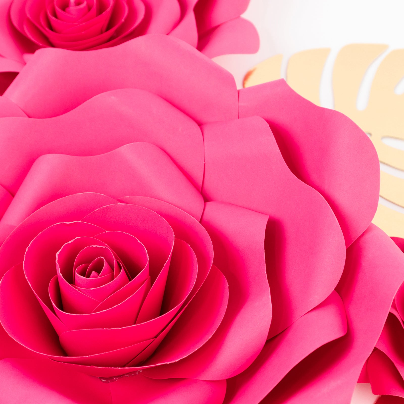 Fuchsia 3D rose paper flowers with gold tropical palm leaves backdrop decor.