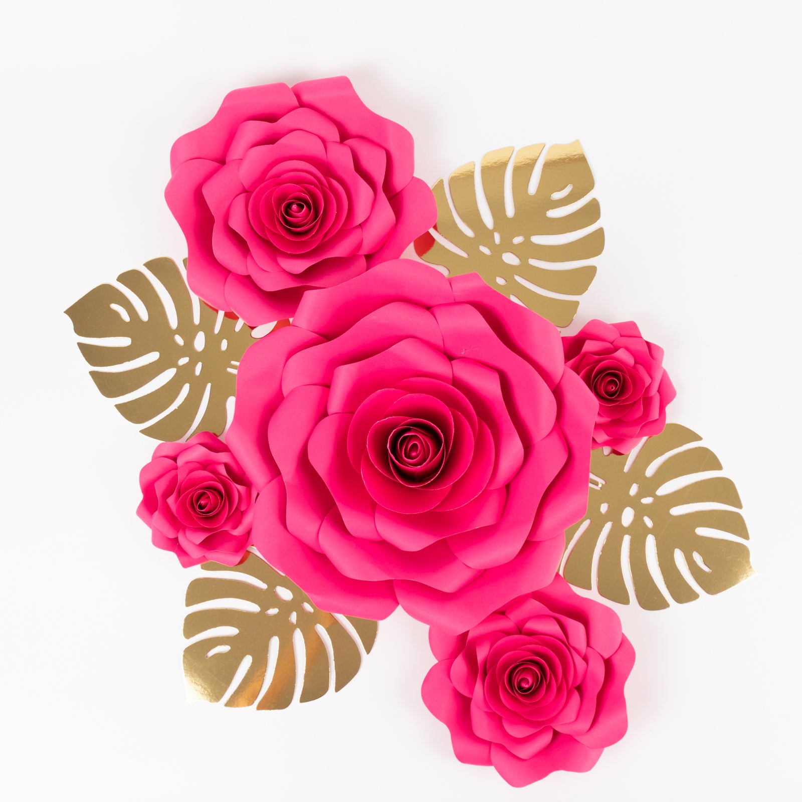 Fuchsia 3D rose paper flowers with gold tropical palm leaves decor.