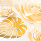 Ivory 3D rose paper flowers with gold tropical palm leaves for decor.