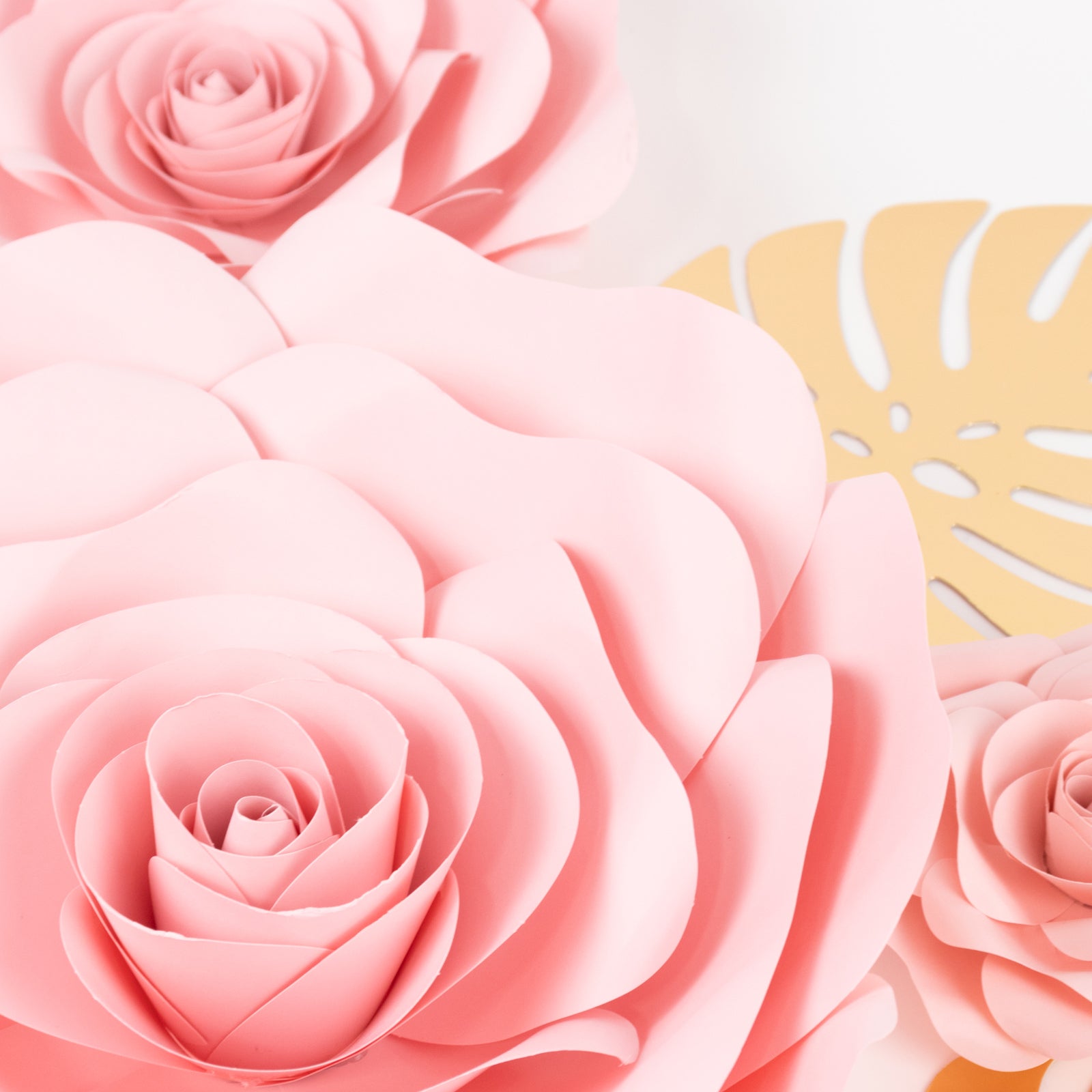 Set of 9 pink 3D rose paper flowers with gold tropical palm leaves.