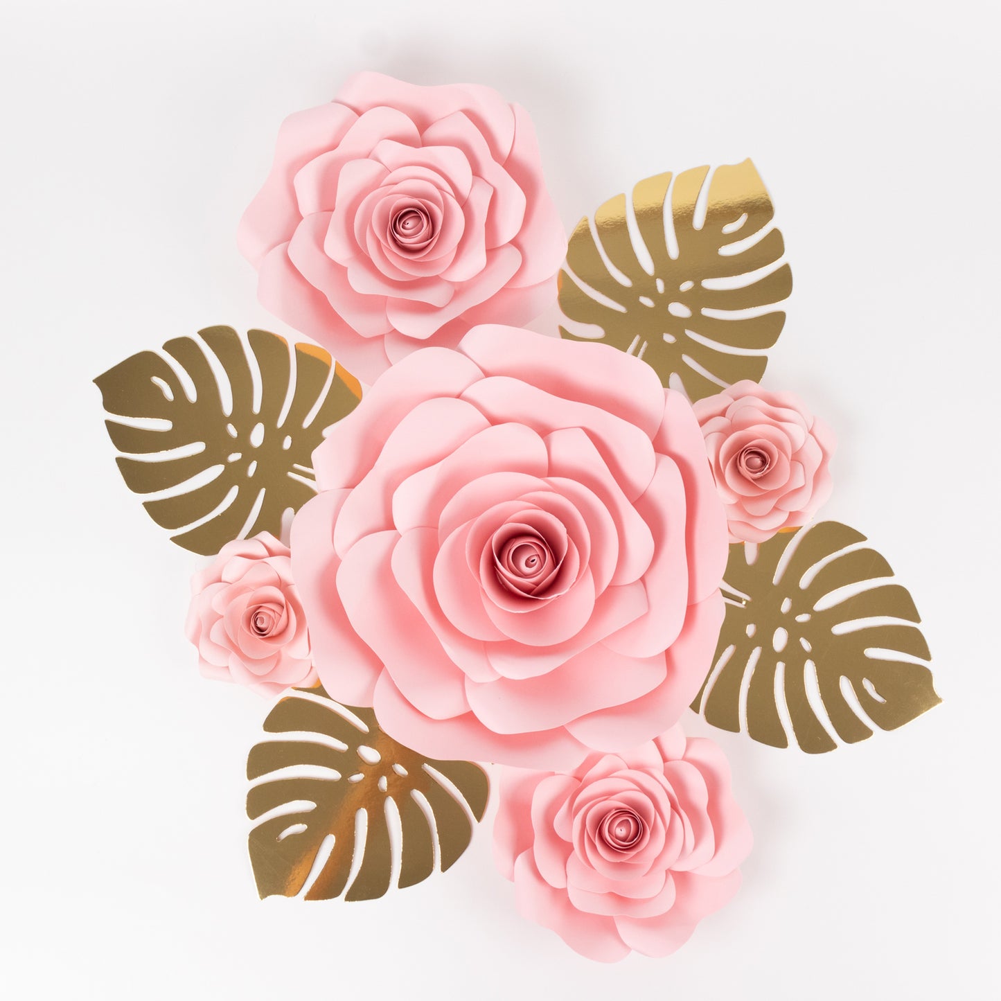 Set of 9 pink 3D rose paper flowers with gold palm leaves for decor.