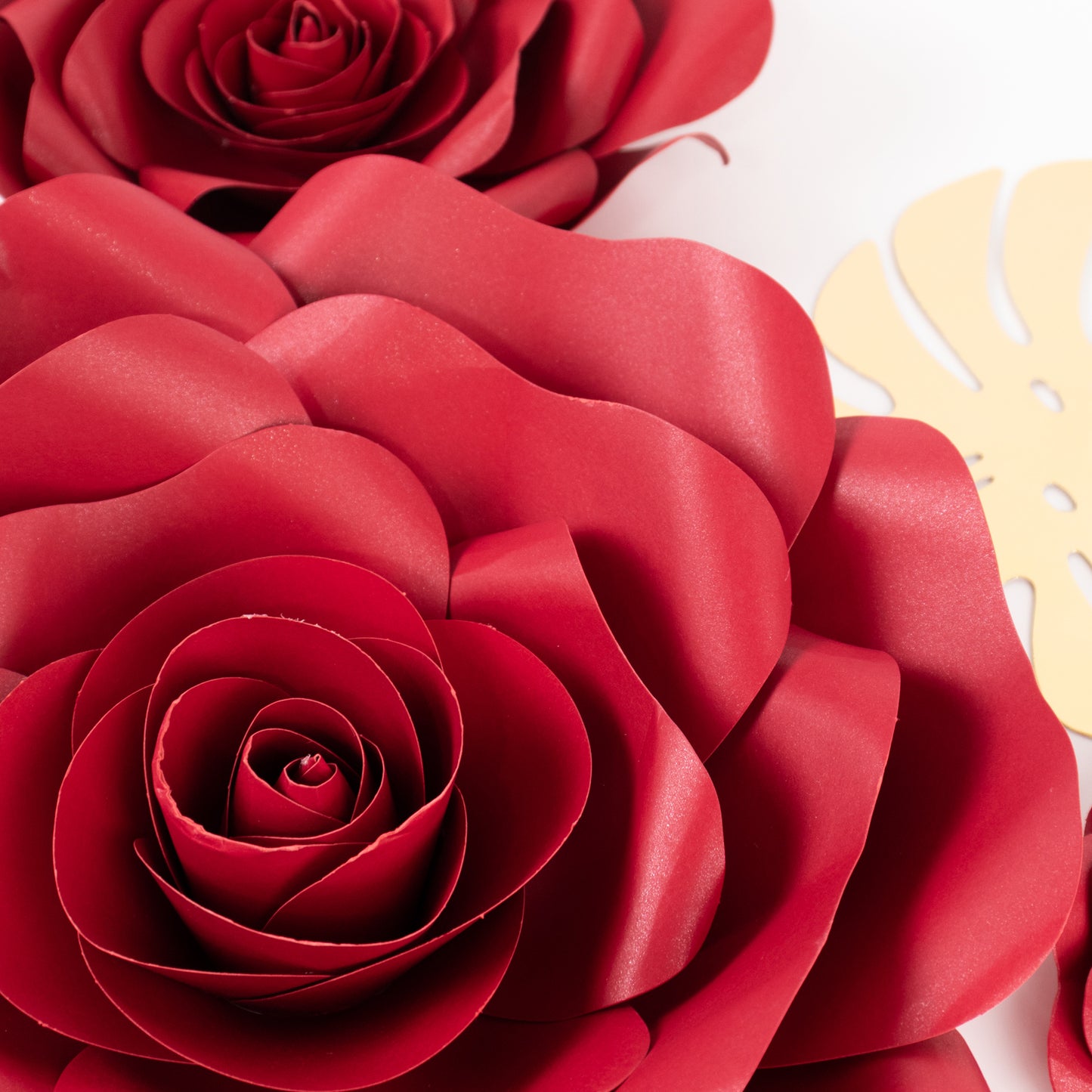 Set of 9 red 3D rose paper flowers with gold tropical palm leaves.
