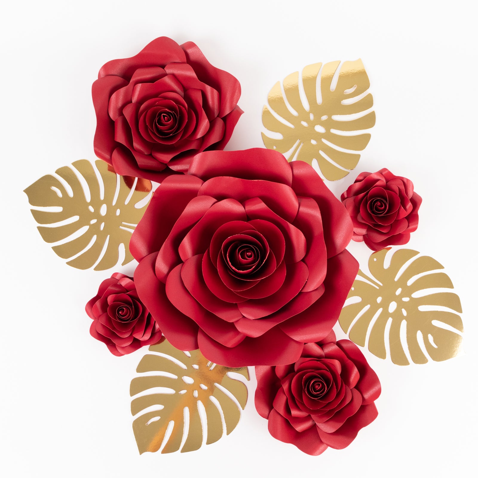 Set of red 3D rose paper flowers with gold palm leaves for wall decor.