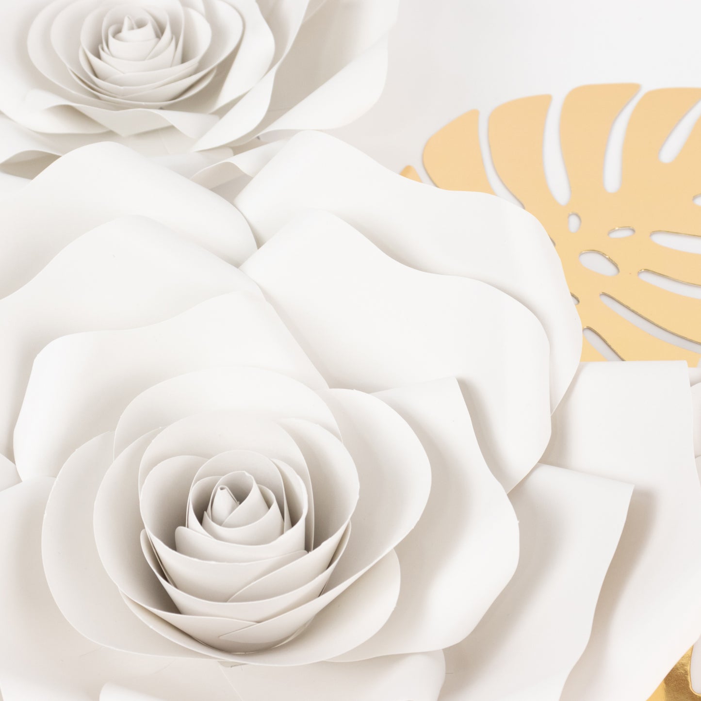 Set of 9 white 3D rose paper flowers with gold palm leaves.