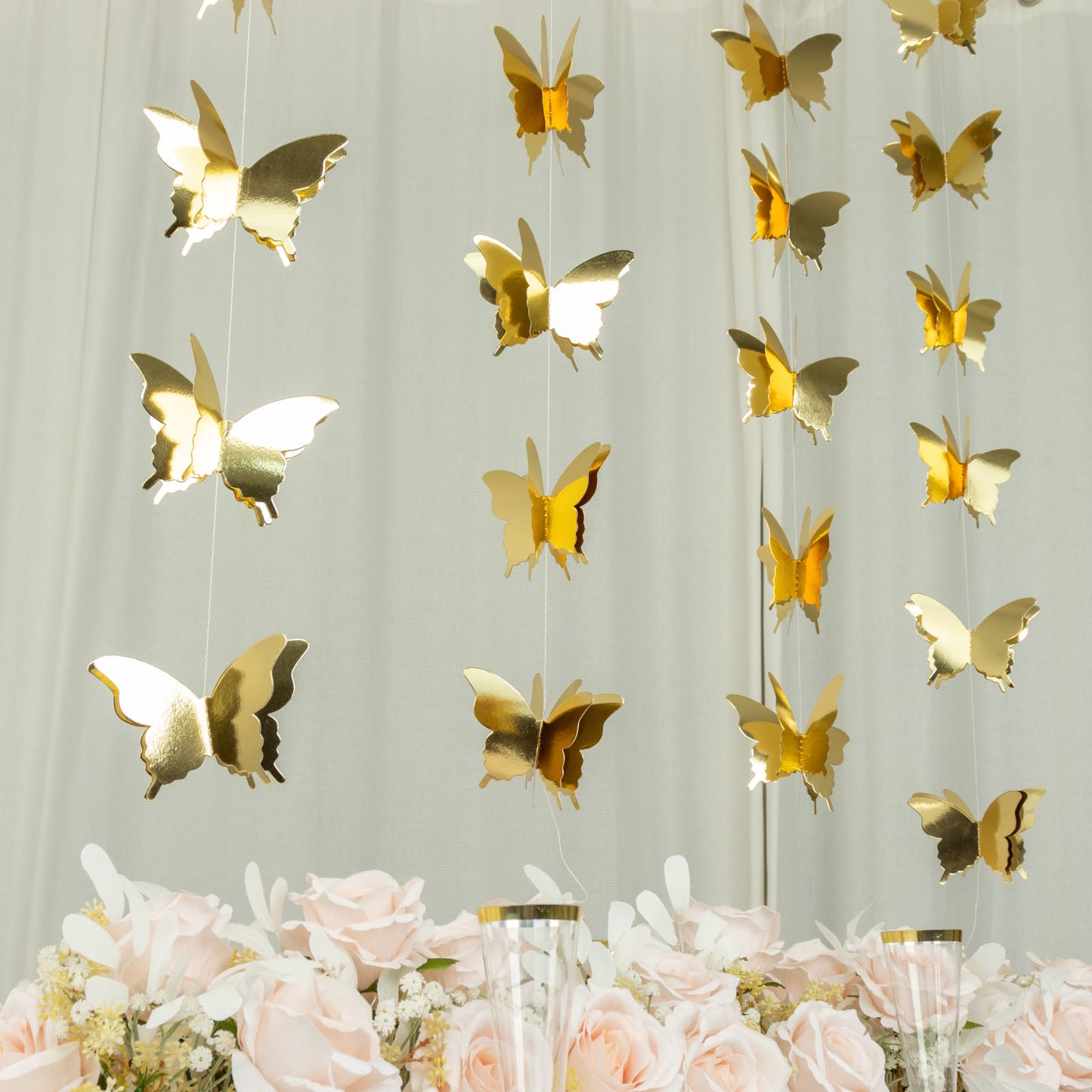 Gold 3D paper butterfly garland streamers for party decor.