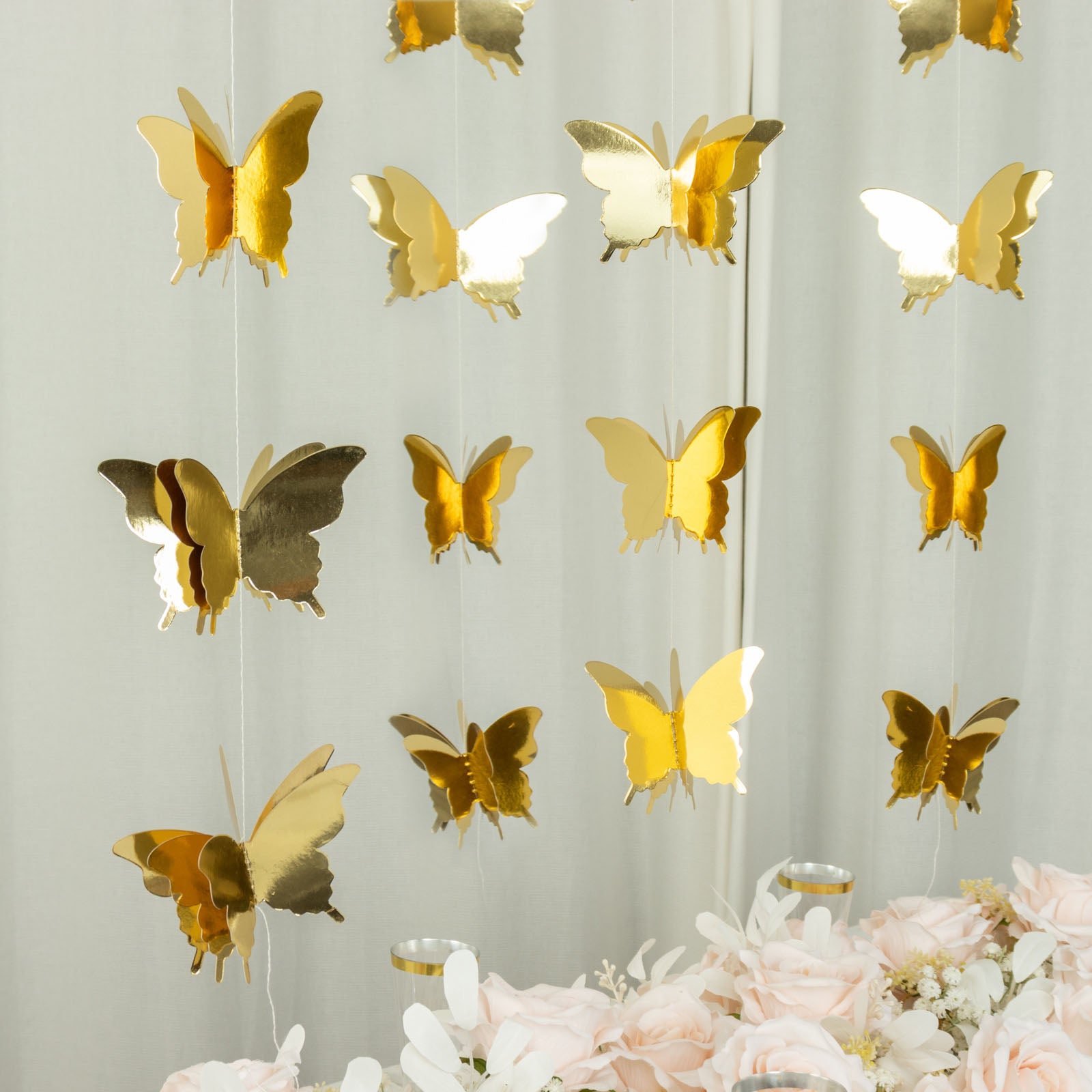 Gold 3D paper butterfly garland streamers for party decoration.