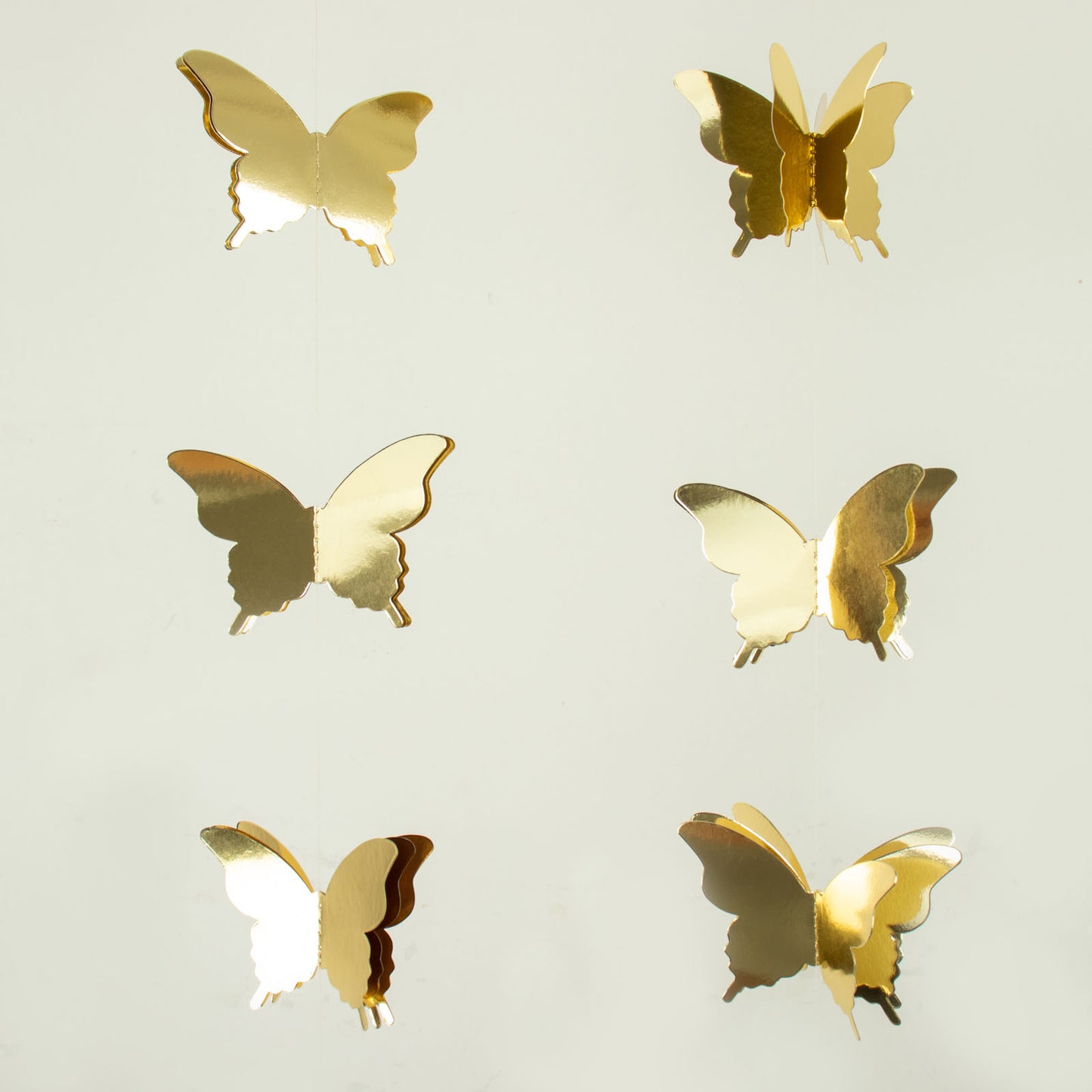 Gold 3D paper butterfly garland streamers for party decoration.