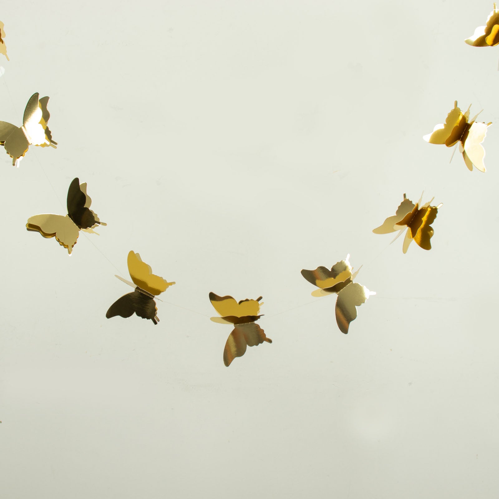 Gold 3D paper butterfly garland streamers for party decoration.