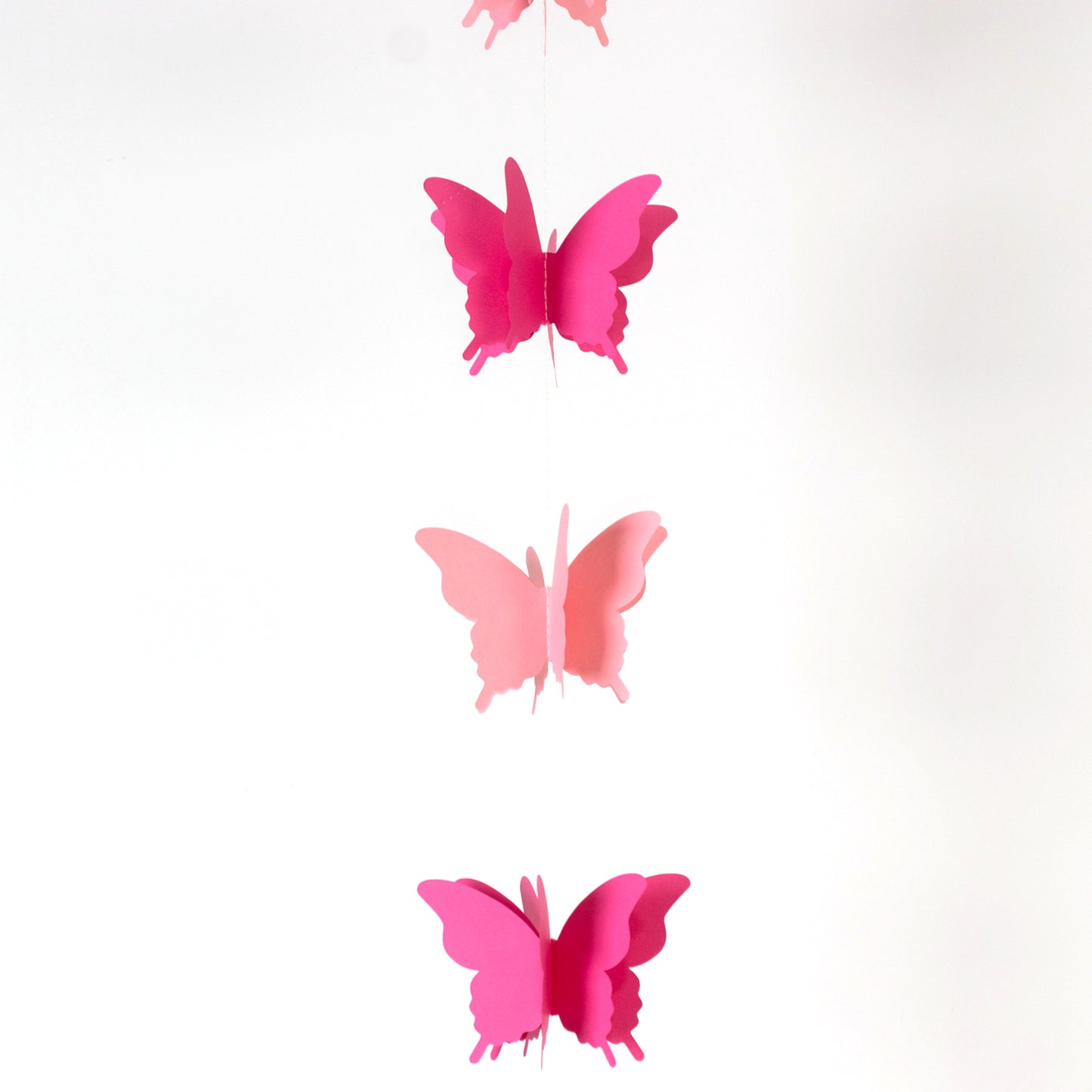 Pink 3D paper butterfly garland streamers for party decoration.