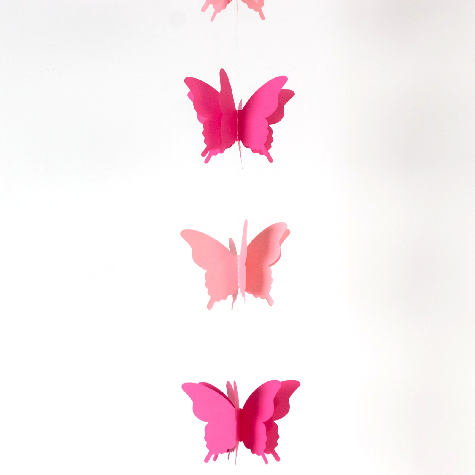 Pink 3D paper butterfly garland streamers for party decoration.