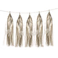 Antique gold paper fringe tassels hanging on a string garland.