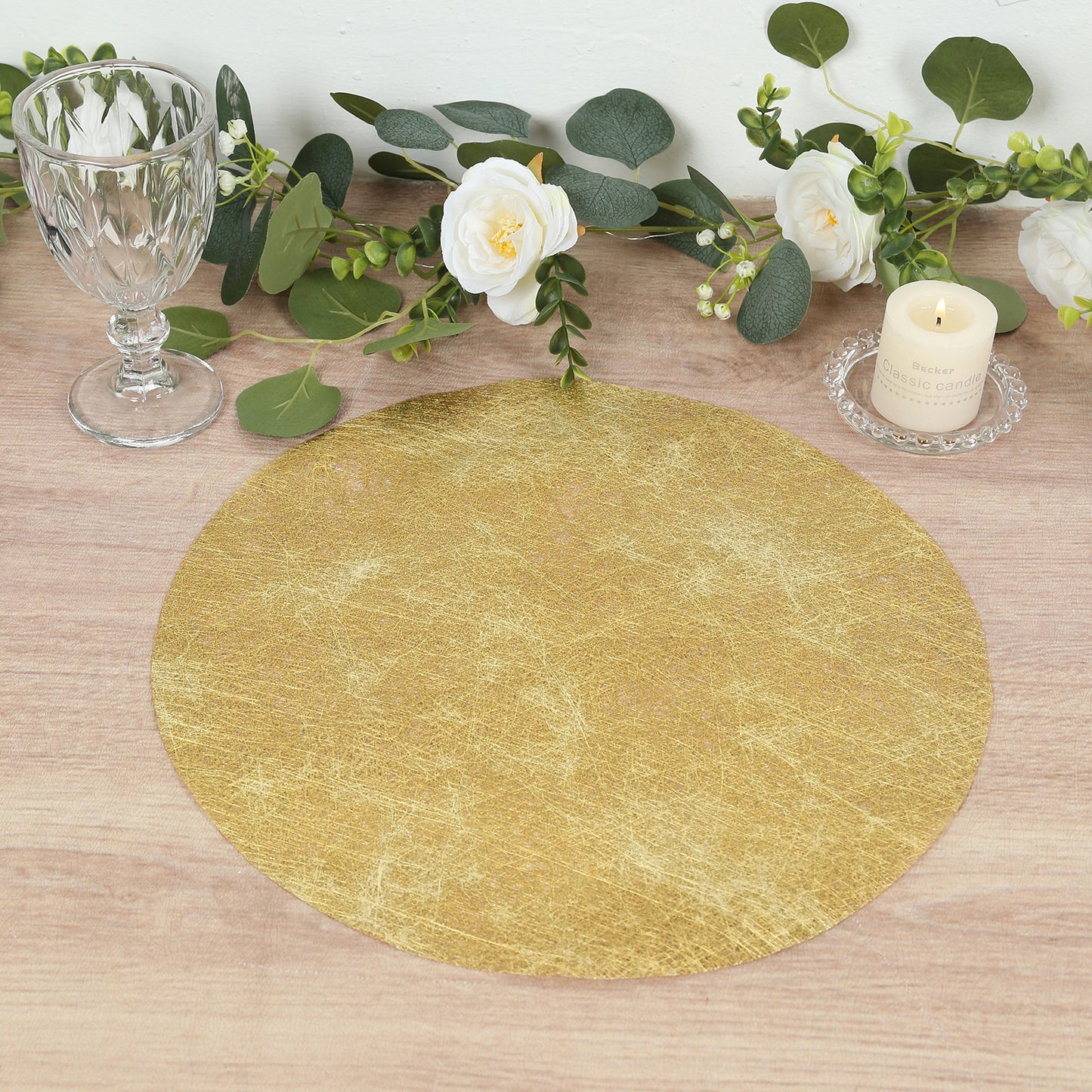 Metallic gold round placemat on a dining table with decor.